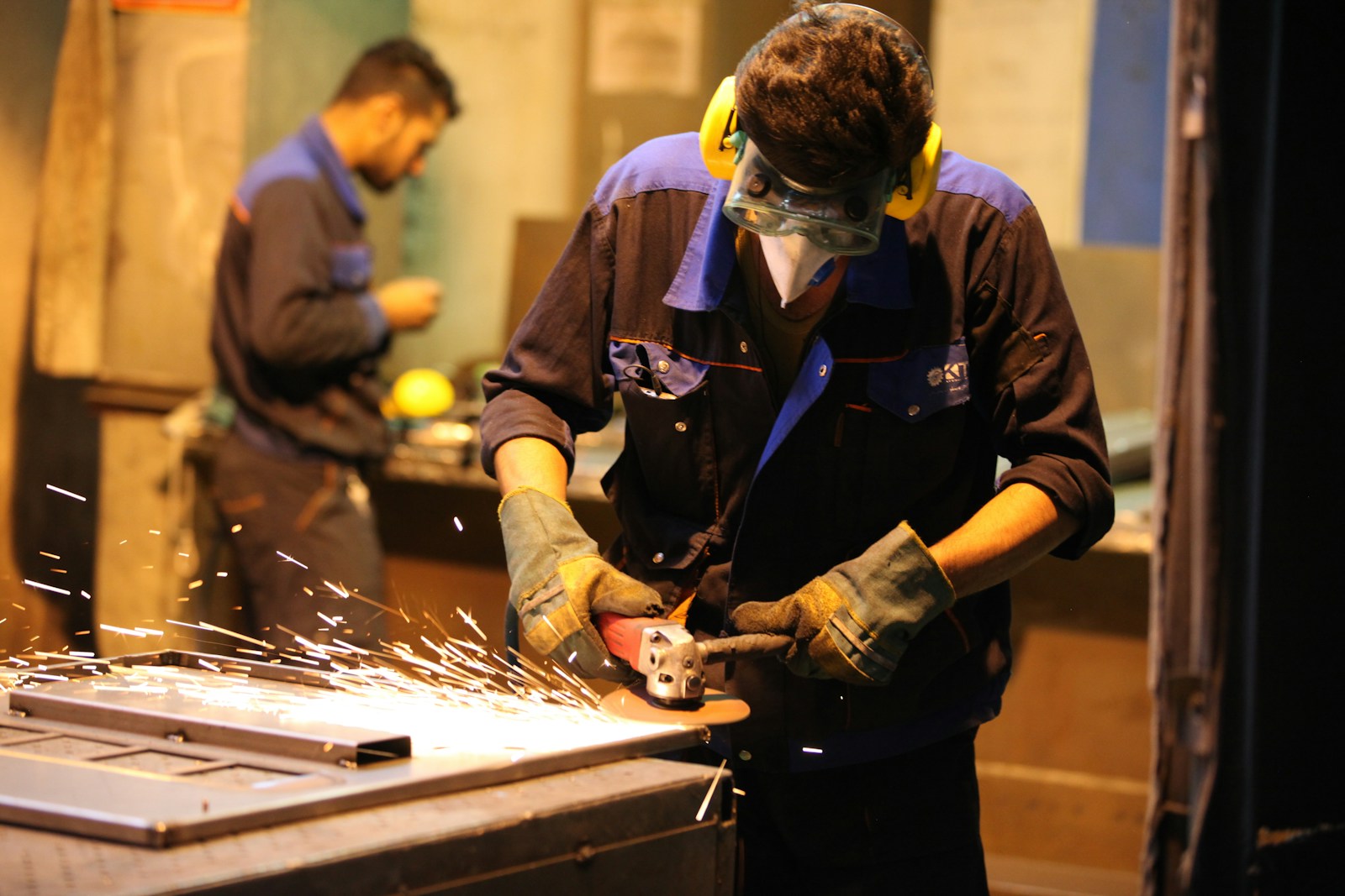man in black long sleeve shirt holding gray metal tool, workers’ compensation